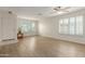 Inviting living room with light wood floors, plantation shutters on the windows, and ample natural light at 3363 W Lone Cactus Dr, Phoenix, AZ 85027