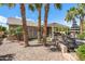 View of the backyard showcasing the covered patio, artificial grass, and rock landscaping at 3801 N 154Th Ln, Goodyear, AZ 85395