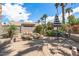 Backyard with a patio, built-in rock waterfall, palm trees, and lush landscaping at 3801 N 154Th Ln, Goodyear, AZ 85395