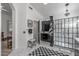 Bright bathroom featuring a glass shower, black vanity, stool and black and white checkered rug at 3801 N 154Th Ln, Goodyear, AZ 85395