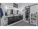 Bathroom featuring a double vanity, mirrored door, and black and white checkered rug at 3801 N 154Th Ln, Goodyear, AZ 85395