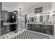 Updated bathroom with dual vanities, glass-enclosed shower, and black and white checkered floor at 3801 N 154Th Ln, Goodyear, AZ 85395