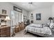 Cozy bedroom features a ceiling fan, neutral-colored walls, a window with shutters and tasteful decor at 3801 N 154Th Ln, Goodyear, AZ 85395