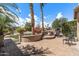 Inviting front courtyard with a charming seating area and mature landscaping, perfect for relaxing at 3801 N 154Th Ln, Goodyear, AZ 85395