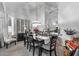 Well lit Dining Room with table set for six, light fixture and large window with plantation shutters at 3801 N 154Th Ln, Goodyear, AZ 85395