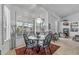 Bright dining area features a round table, four chairs, and window shutters overlooking the outdoor scenery at 3801 N 154Th Ln, Goodyear, AZ 85395