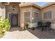 Charming front entryway with a decorative door, brick pavers, and lovely potted plants at 3801 N 154Th Ln, Goodyear, AZ 85395