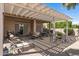 Covered patio with outdoor seating, a grill, and view of landscaped backyard at 3801 N 154Th Ln, Goodyear, AZ 85395