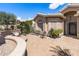 Private front patio featuring a decorative fountain, seating area, and lush landscaping at 3801 N 154Th Ln, Goodyear, AZ 85395