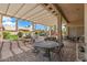 Relax on this covered patio with lots of shade in a well-manicured backyard oasis at 3801 N 154Th Ln, Goodyear, AZ 85395