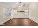 Bedroom featuring wood floors, ceiling fan, and bright, sunlit windows at 4622 E Fairbrook Cir, Mesa, AZ 85205