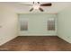 Bedroom featuring ceiling fan, natural light, and beautiful wood floors at 4622 E Fairbrook Cir, Mesa, AZ 85205