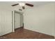 Bedroom features wood-look flooring, a ceiling fan, and closet at 4622 E Fairbrook Cir, Mesa, AZ 85205