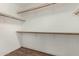 Spacious walk-in closet with wooden shelves and wood-look flooring at 4622 E Fairbrook Cir, Mesa, AZ 85205