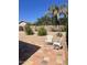 A serene backyard featuring mature trees, a patio, and gravel landscaping at 4728 E Swilling Rd, Phoenix, AZ 85050