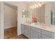 Bright bathroom featuring dual sinks, neutral paint, and tiled flooring throughout at 4728 E Swilling Rd, Phoenix, AZ 85050