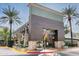 Grand entrance to the District, framed by towering palm trees and unique architectural features at 4728 E Swilling Rd, Phoenix, AZ 85050