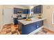 Modern kitchen with blue cabinets, a center island, and tile backsplash at 4728 E Swilling Rd, Phoenix, AZ 85050