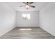 Bright bedroom featuring a window, and neutral gray wood-look flooring at 5716 W Hazelwood St, Phoenix, AZ 85031