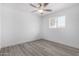 Bedroom featuring sleek, neutral wood-look flooring and natural light at 5716 W Hazelwood St, Phoenix, AZ 85031