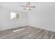 Bedroom featuring sleek, neutral wood-look flooring and natural light at 5716 W Hazelwood St, Phoenix, AZ 85031