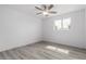 Bedroom featuring sleek, neutral wood-look flooring and natural light at 5716 W Hazelwood St, Phoenix, AZ 85031