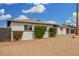 Side view showcasing the home's exterior, landscaping, and detached garage at 5716 W Hazelwood St, Phoenix, AZ 85031