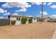 Side view showcasing the home's exterior, landscaping, and detached garage at 5716 W Hazelwood St, Phoenix, AZ 85031