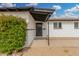 View showcasing the home's front door, shrubbery, and covered entrance at 5716 W Hazelwood St, Phoenix, AZ 85031