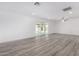 Spacious living room with modern floors, recessed lighting, and sliding door to the backyard at 5716 W Hazelwood St, Phoenix, AZ 85031