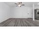 Bright living room with gray wood-look floors and ample space for versatile furniture arrangement at 5716 W Hazelwood St, Phoenix, AZ 85031