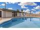 Sparkling pool with covered patio, landscaping, and privacy fencing in the backyard at 5716 W Hazelwood St, Phoenix, AZ 85031