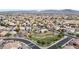 An expansive aerial perspective captures a residential community with verdant parks amidst tiled-roofed homes at 6221 S 45Th Gln, Laveen, AZ 85339