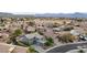 Aerial shot showcases a residential neighborhood with well-maintained homes, green spaces, and mountain views at 6221 S 45Th Gln, Laveen, AZ 85339