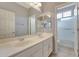 Bathroom featuring double sinks, a large mirror, and a shower/tub combination at 6221 S 45Th Gln, Laveen, AZ 85339