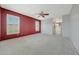 Expansive bedroom with plush carpet, ceiling fan, and bright natural light from the multiple windows at 6221 S 45Th Gln, Laveen, AZ 85339