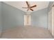 Bedroom featuring neutral colored walls, carpeted flooring, and a ceiling fan at 6221 S 45Th Gln, Laveen, AZ 85339