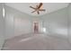 Bedroom featuring plush carpeting, ceiling fan, and closet with bright, natural light at 6221 S 45Th Gln, Laveen, AZ 85339