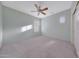 Neutral bedroom with carpet, ceiling fan, and bright, natural light through shuttered windows at 6221 S 45Th Gln, Laveen, AZ 85339