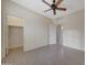 Neutral bedroom with a ceiling fan, en-suite bathroom, walk-in closet, and tile floor at 6221 S 45Th Gln, Laveen, AZ 85339