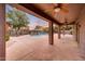 View of covered patio overlooking backyard pool with ample space for outdoor entertaining at 6221 S 45Th Gln, Laveen, AZ 85339