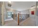 Upstairs hallway with carpeted floors and decorative railing overlooking the stairway at 6221 S 45Th Gln, Laveen, AZ 85339