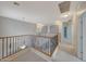 Carpeted upstairs hallway featuring decorative railing and recessed lighting at 6221 S 45Th Gln, Laveen, AZ 85339