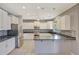 Modern kitchen featuring white cabinetry, stainless steel appliances, and a functional island at 6221 S 45Th Gln, Laveen, AZ 85339