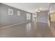 Bright living room featuring tile floors, neutral paint, and view to the kitchen and staircase at 6221 S 45Th Gln, Laveen, AZ 85339