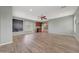 Living room with hardwood-style flooring, a mini-fridge, and views of the upstairs hallway at 6221 S 45Th Gln, Laveen, AZ 85339