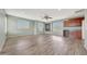 Large living room with wood floors, a mini-fridge, and bright, natural light from shuttered windows at 6221 S 45Th Gln, Laveen, AZ 85339