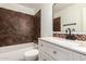 Updated bathroom featuring stylish vanity, sink, and tiled shower and wall accents at 6837 E Osborn Rd # F, Scottsdale, AZ 85251