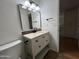 Bathroom featuring a single sink vanity with granite countertops, modern lighting, and a toilet at 6837 E Osborn Rd # F, Scottsdale, AZ 85251