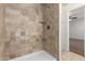 A tiled shower with a built-in shelf and updated fixture at 6837 E Osborn Rd # F, Scottsdale, AZ 85251